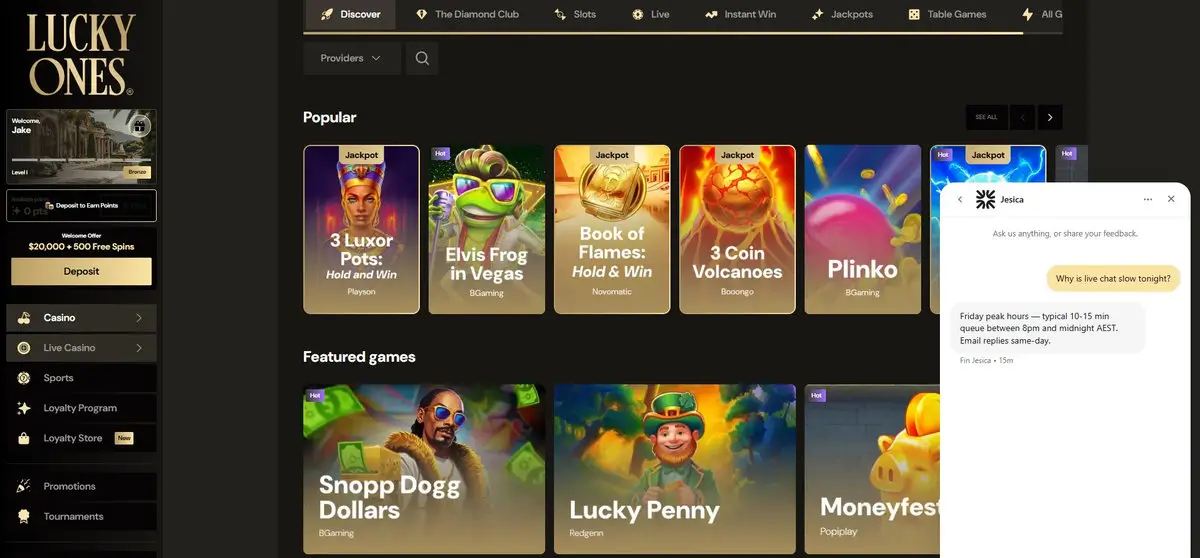 Lucky Ones live-chat window over the Discover lobby: the player asks why live chat is slow, and the agent replies that Friday peak hours run a typical 10 to 15 minute queue between 8pm and midnight AEST, with email replies same-day. Captured July 2026.